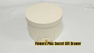 White cylindrical flower box with a drawer
